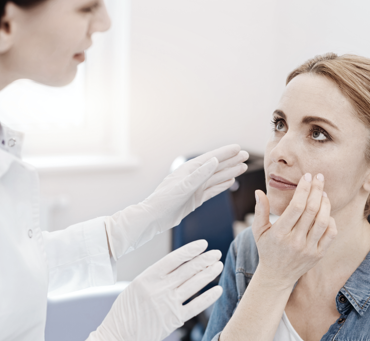 doctor examining patient's face