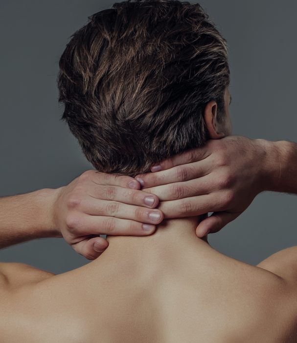 man touching his neck