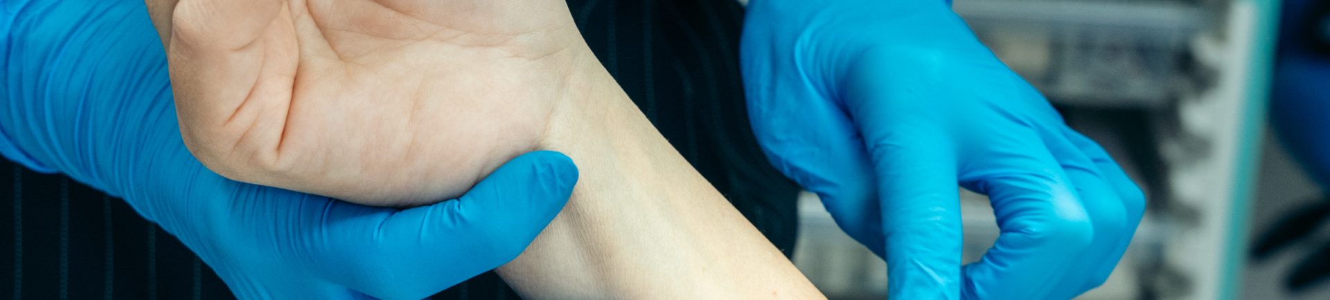 doctor examining patient's skin on her arm