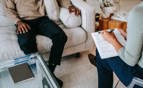 doctor talking to patient on a sofa