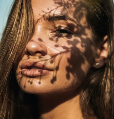 beautiful woman's face with flower shadows on it