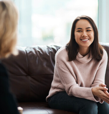 smiling female patient on a sofa