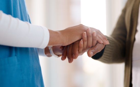 Woman, holding hands or consulting a caregiver for support or empathy for healthcare service.